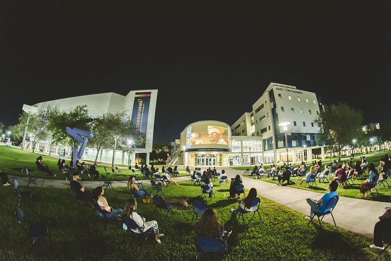 Students relax between classes on the grass 