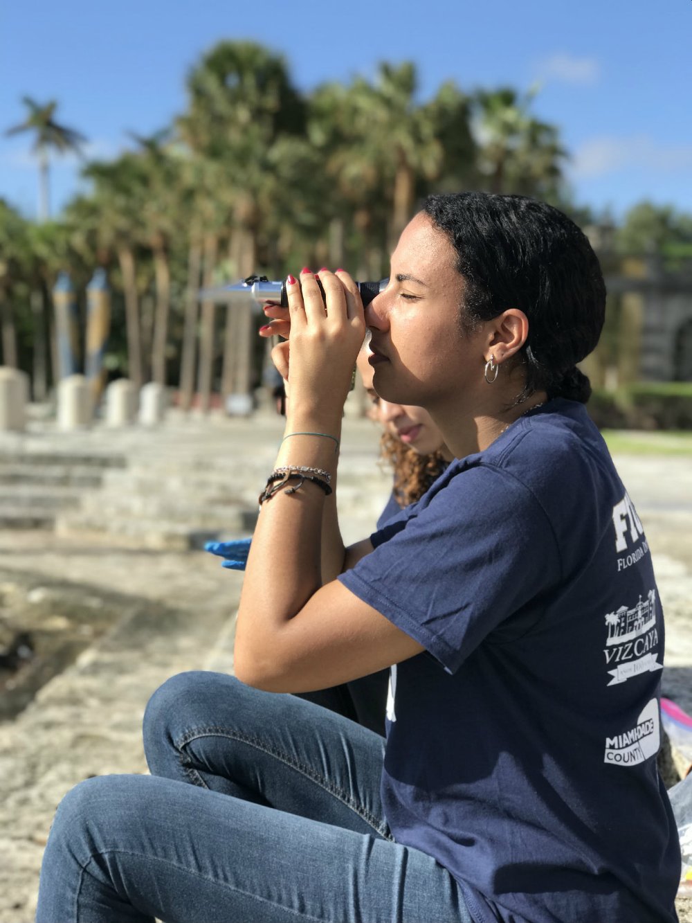 Norhan Elbermawy, FIU student, looks into the refractometer to document salinity content for flooding at the Vizcaya Museum and Gardens.